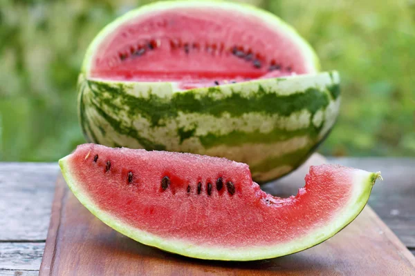 Bir ahşap tahta üzerine dilimler halinde kesip karpuz.