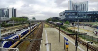 Amsterdam tren istasyonunun gündüz vakti hareket eden tren ve istasyon görüntüsü ve boş istasyon Sloterdijk Hollanda