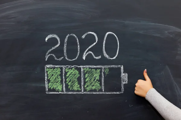 happy new year 2020. Chalkboard with 2020 loading text and loading percentage bar and hand