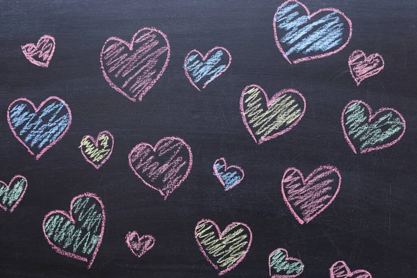 multicolored love hearts drawing on a chalk Board