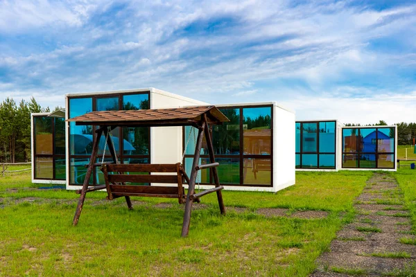 Modular prefabricated houses made of panels with large panoramic windows.