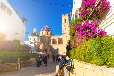 Altea, Spain. November 14, 2017: Tourists near the Church of Our Lady of Consuelo in Altea, in the province of Alicante, Spain. clipart