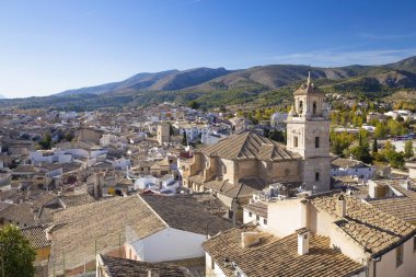Caravaca, Spain - November 17, 2017: panorama of the city of Caravaca de la Cruz with many houses with tiled roofs, a place of pilgrimage near Murcia in Spain. clipart
