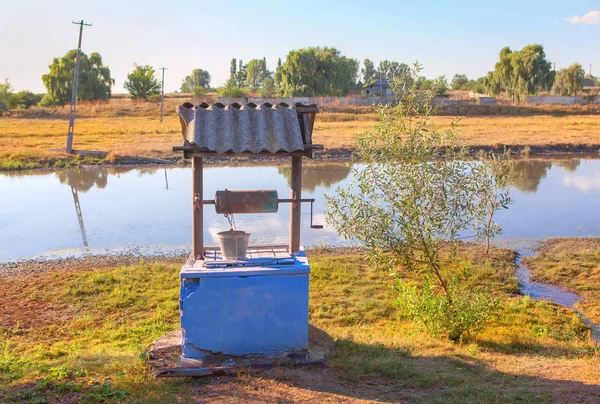 water well on the river shore