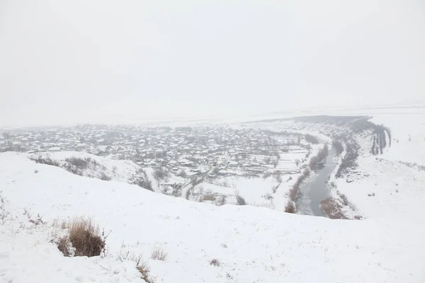 winter panorama with village on the valley