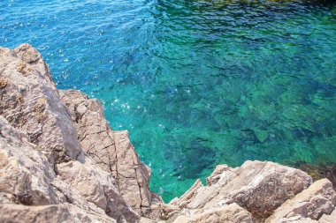 kayalık ve mavi şeffaf su