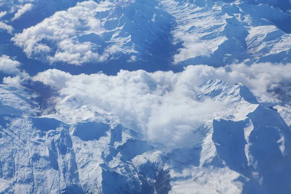 image of clouds and snowy mountains