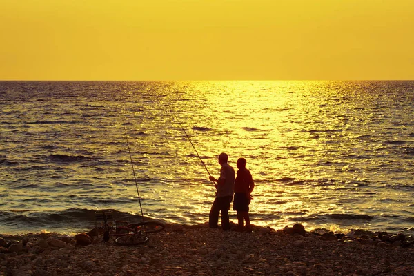 two old man fishing in the evening