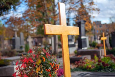 wooden cross on the tomb at graveyard clipart