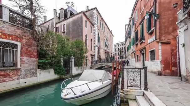 ITALY, VENICE - FEBRUARY 15: Tourists traffic and boat on small canal in Venice 4K — Stock Video