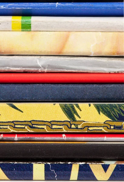 A stack of thin magazines. Closeup of back of magazines  for background