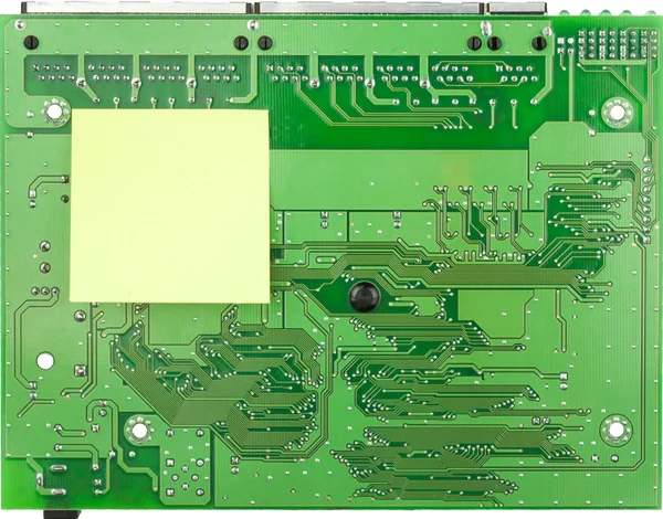 Closeup PCB green board and sticker. Place for your text on the sticker