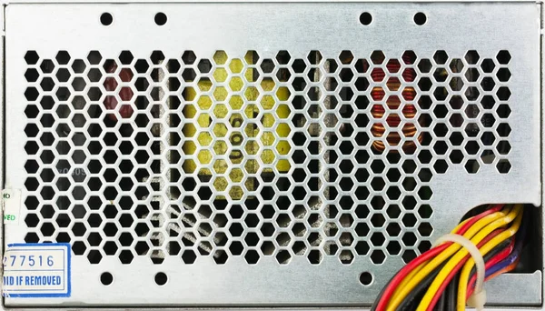 closeup used computer power supply grid with color wireds