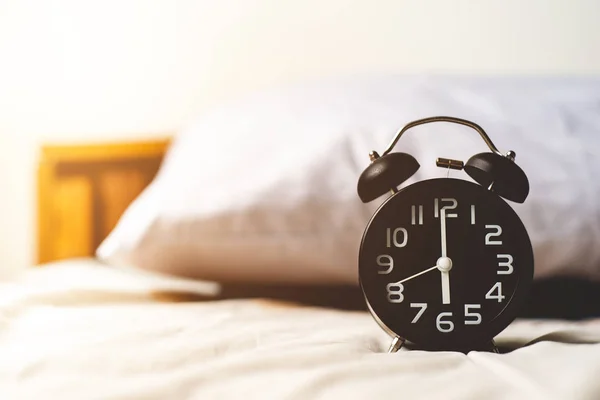 Morning time background,Alarm clock on bedroom in the morning — Stock Photo, Image