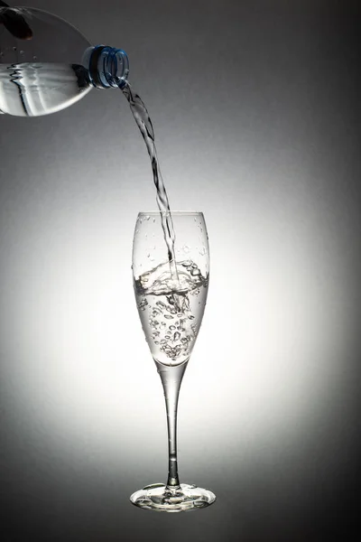 A glass of water, water splashing from glass on white background