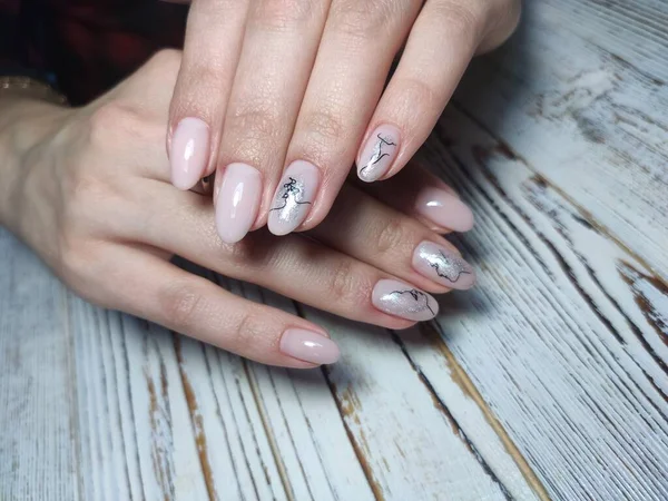 Beautiful nail design on female hands on background. 2019