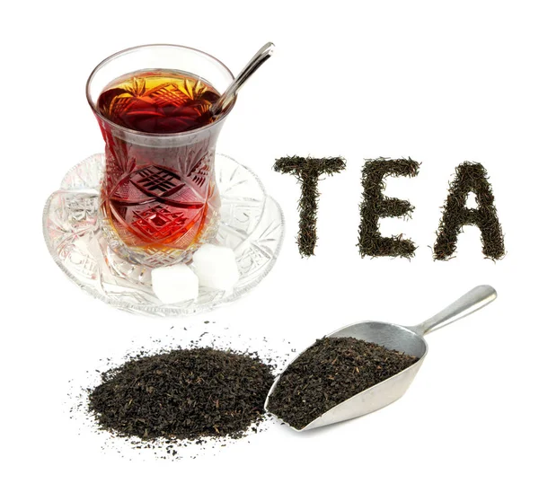 Turkish tea in traditional crystal glass and dry black tea leaves . — Stock Photo, Image