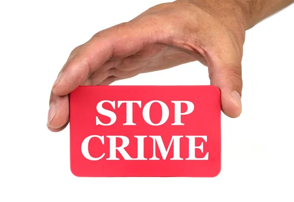 Mano sosteniendo y mostrando una tarjeta roja con texto "STOP CRIME" — Foto de Stock