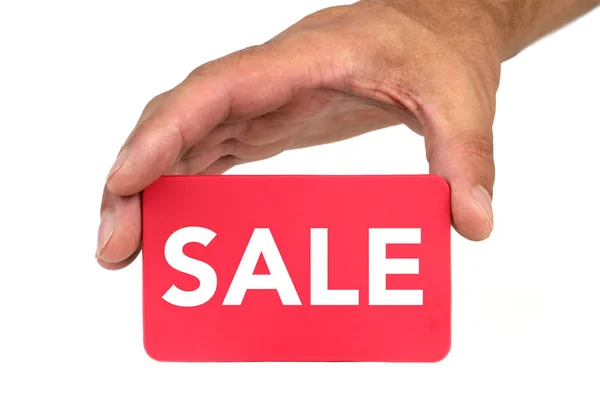 Ręka trzyma i pokazano czerwoną kartkę z tekstem "Sprzedaż" — Zdjęcie stockowe