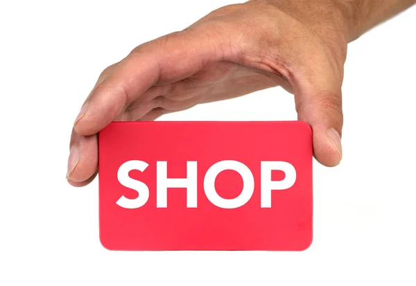 Mão segurando e mostrando um cartão vermelho com texto "SHOP" — Fotografia de Stock