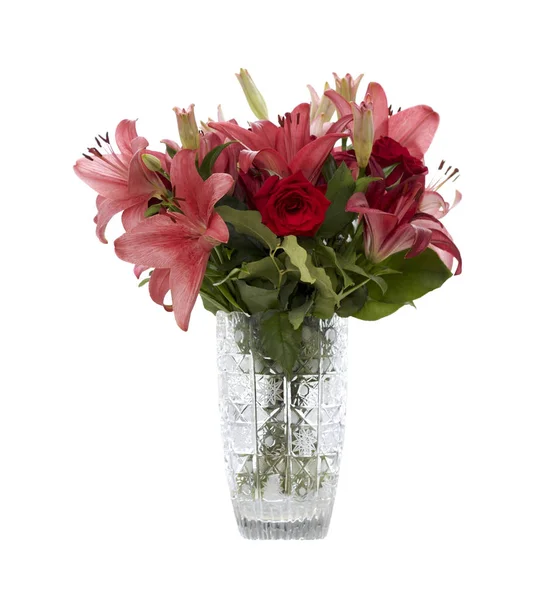 Red and pink lilies in a crystal vase — Stock Photo, Image