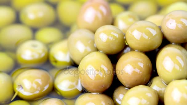 Pouring olive oil on green olives — Stock Video
