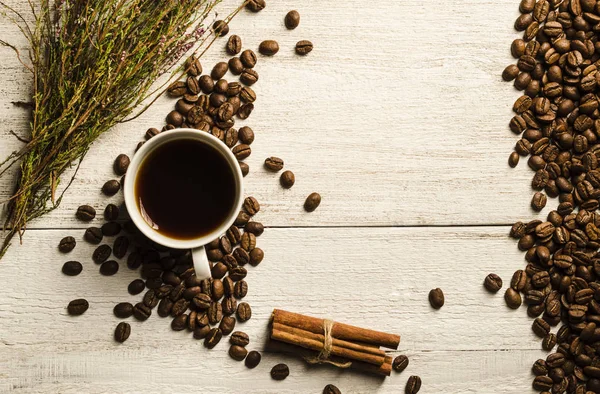 ?up with coffee, cezve coffee grains,heather on a light wooden background. Romantic evening,Top view