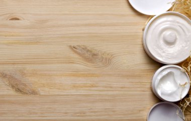 Yüz ve vücut derisi bakımı için doğal kozmetik ürünleri. Organik güzellik. Vücut bakımı. Üst manzara, açık ahşap arkaplan.