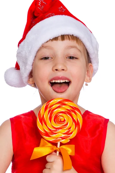 Retrato de Natal de uma menina, chapéu de Papai Noel com doces — Fotografia de Stock
