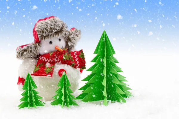 Christmas background, snowman with paper trees in the snow — Stock Photo, Image