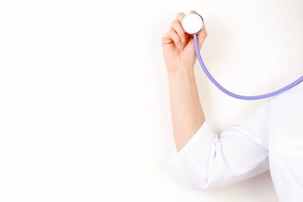 Doctor with a stethoscope in the hands on white background — Stock Photo, Image