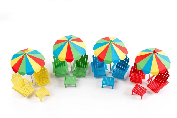 Paper beach umbrellas and chair on a white background. Isolated background. — Stock Photo, Image