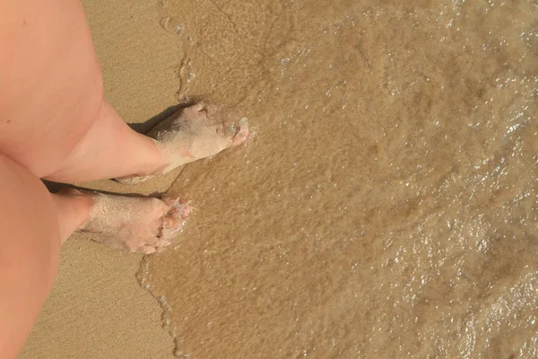 女性的脚在沙子里 在沙滩上的女性脚上留下了脚印 — 图库照片