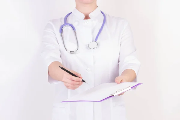 Doctor en bata blanca con estetoscopio, con carpeta en la mano, sobre fondo blanco aislado . —  Fotos de Stock