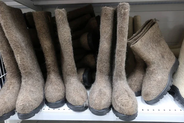 traditional Russian winter shoes felt felt boots with rubber soles on a shelf in the store