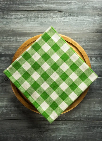 Napkin and board on wooden background — Stock Photo, Image