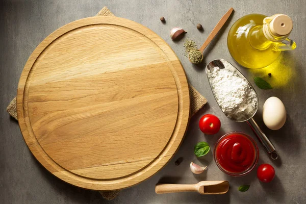 Pizza cutting board at table — Stock Photo, Image