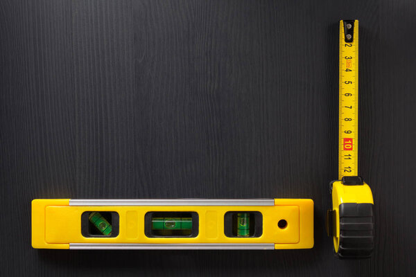 tape measure and level on wood