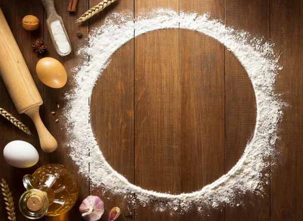 flour powder and  bakery ingredients on wood