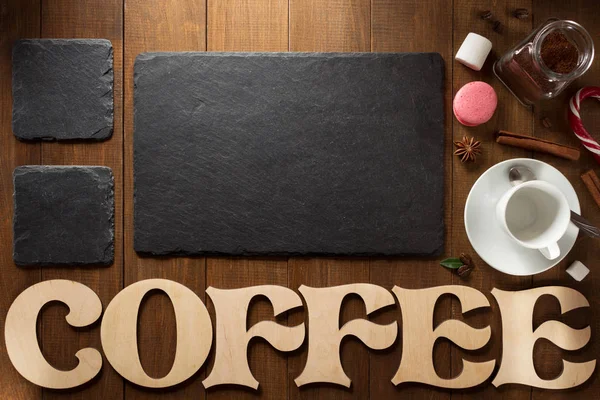 Cup of coffee and letters on wood — Stock Photo, Image