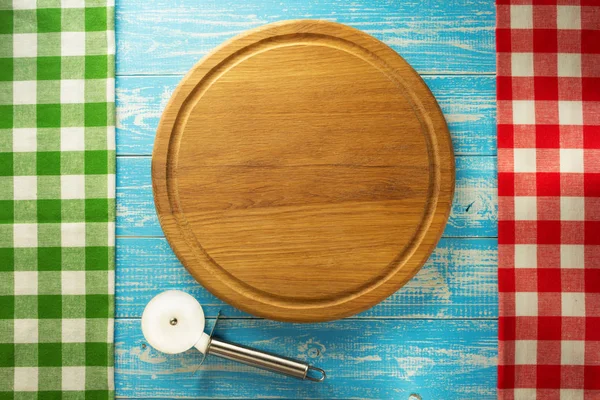 Pizza cutting board at wood — Stock Photo, Image