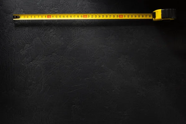 Tape measure  on black — Stock Photo, Image