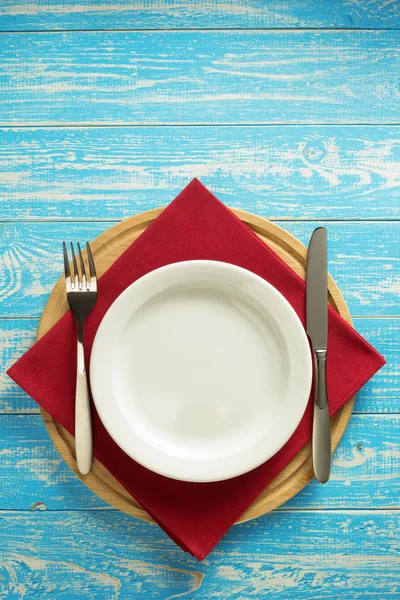 Plate, knife and fork on rustic background — Stock Photo, Image