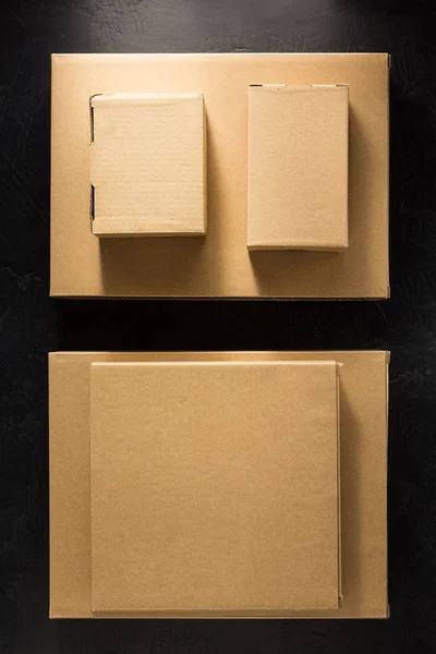 Cardboard box on black background — Stock Photo, Image