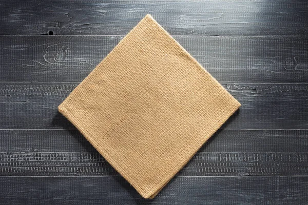 Burlap hessian napkin on wood — Stock Photo, Image