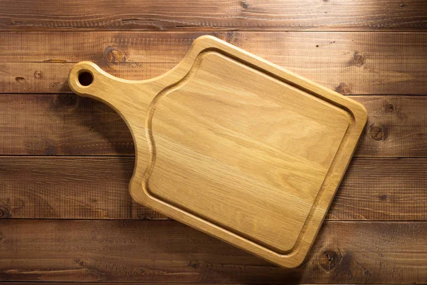 Cutting board at wood — Stock Photo, Image