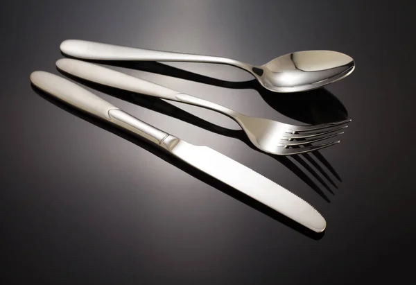 Knife, spoon and fork on black — Stock Photo, Image