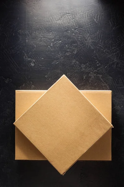 Cardboard box on black background — Stock Photo, Image