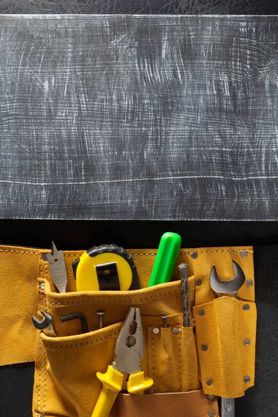 Tools and instruments in belt on black — Stock Photo, Image