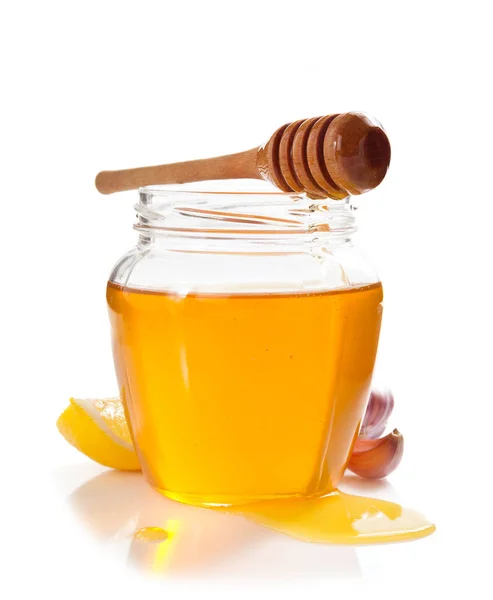 Glass jar full of honey and dipper — Stock Photo, Image